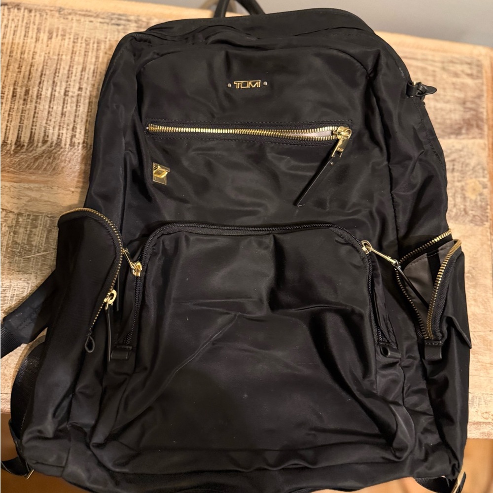 Tumi Black Backpack with Gold Accents